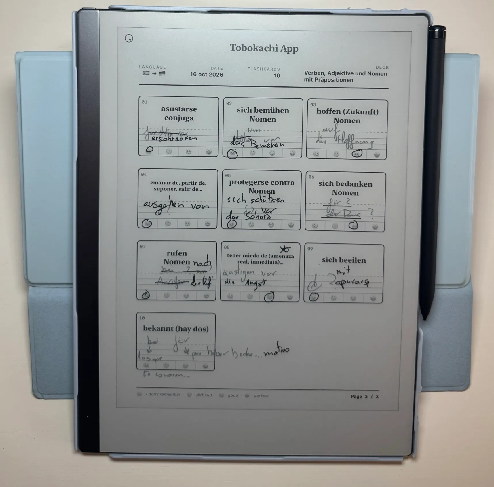 An e-ink tablet showing a Tobokachi study sheet with ten German flashcards answered by hand with a stylus.